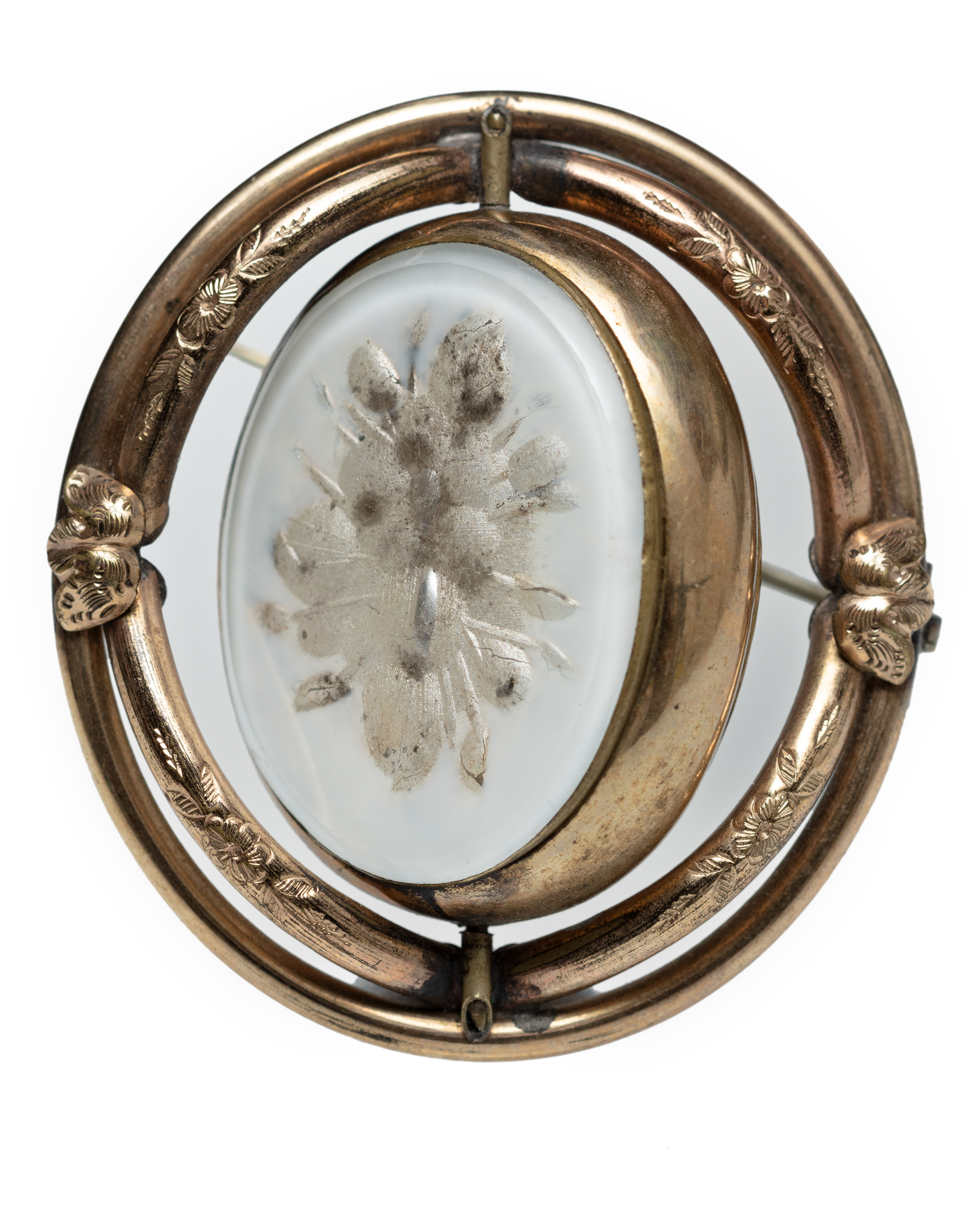 Unidentified photographer, [Double-sided brooch with photographic portrait and floral motif], [date unknown] (brass, dried flowers, tintype). Courtesy of the Howard and Carole Tanenbaum Photography Collection