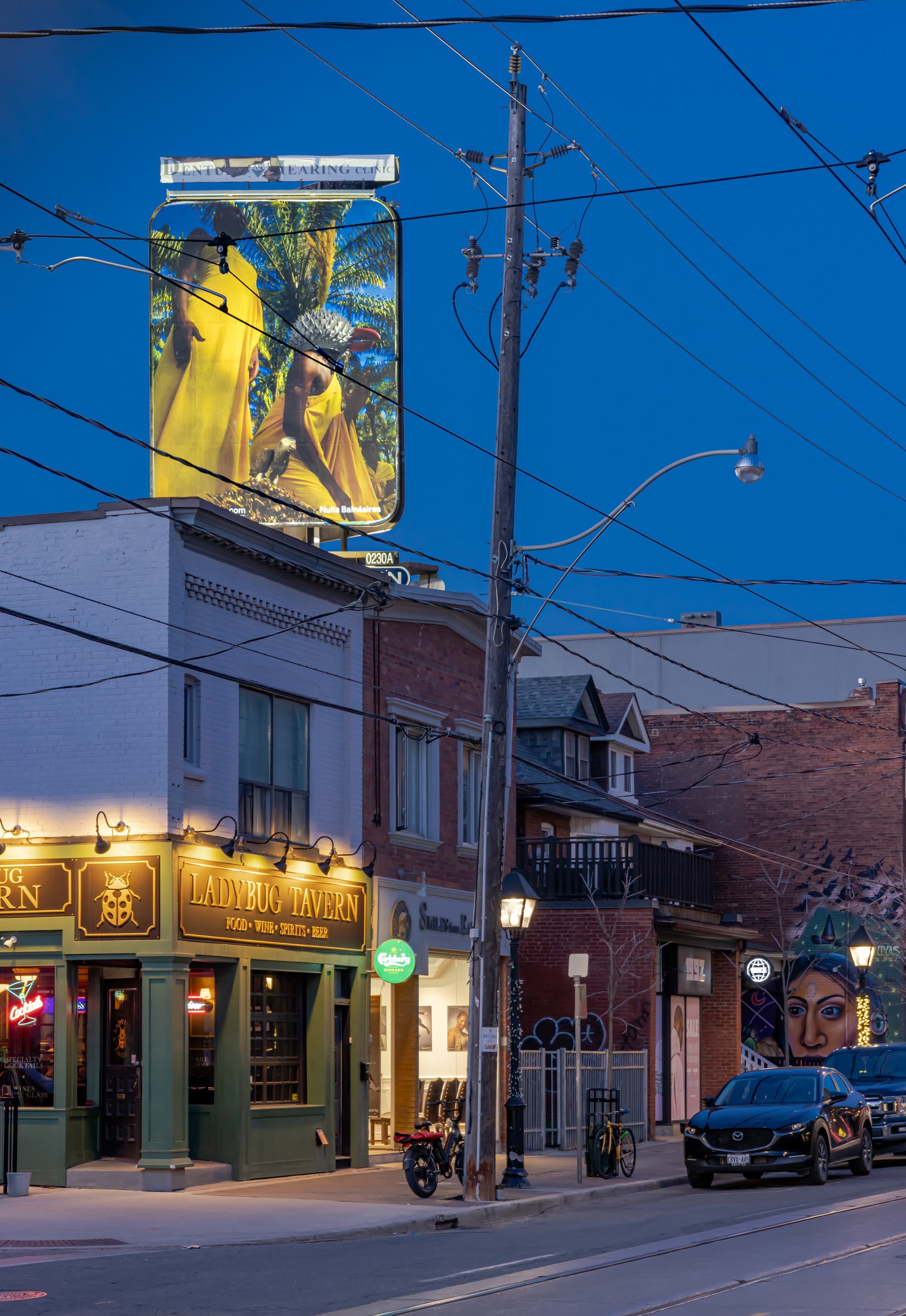     Nuits Balnéaires, Window into Bassam, 2024, installation view, billboards at College St and Delaware Ave. Courtesy of the artist and CONTACT Photography Festival. Photo: Toni Hafkenscheid

