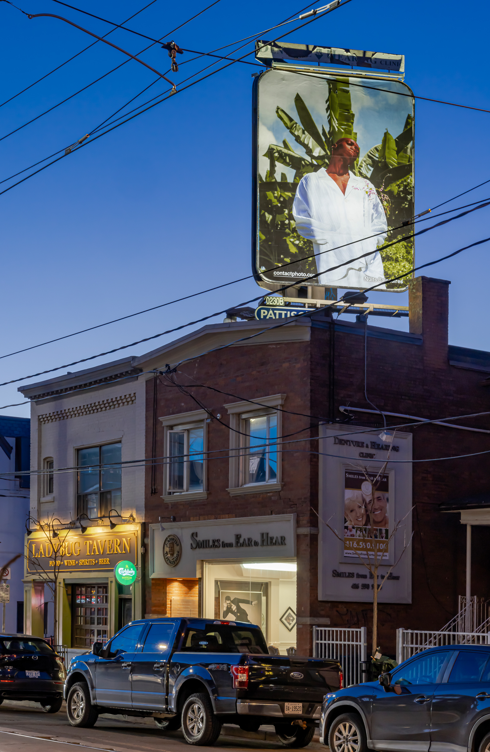     Nuits Balnéaires, Window into Bassam, 2024, installation view, billboards at College St and Delaware Ave. Courtesy of the artist and CONTACT Photography Festival. Photo: Toni Hafkenscheid

