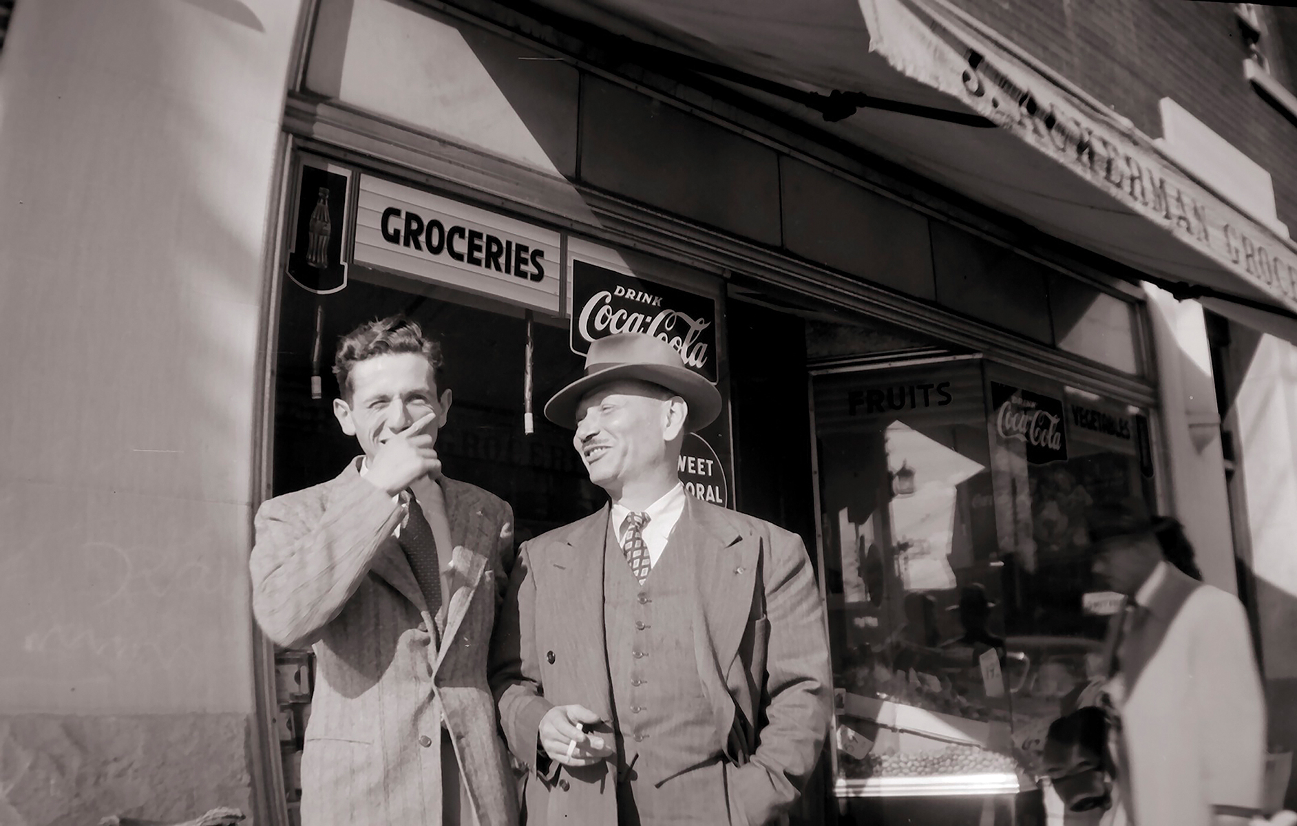     John E. Ackerman, Men outside Ackerman&#8217;s Grocery Store, C. 1940. Archival pigment print, 5 x 7”. © Ontario Jewish Archives, Blankenstein Family Heritage Centre (UJA Federation), accession 2013-7-13

