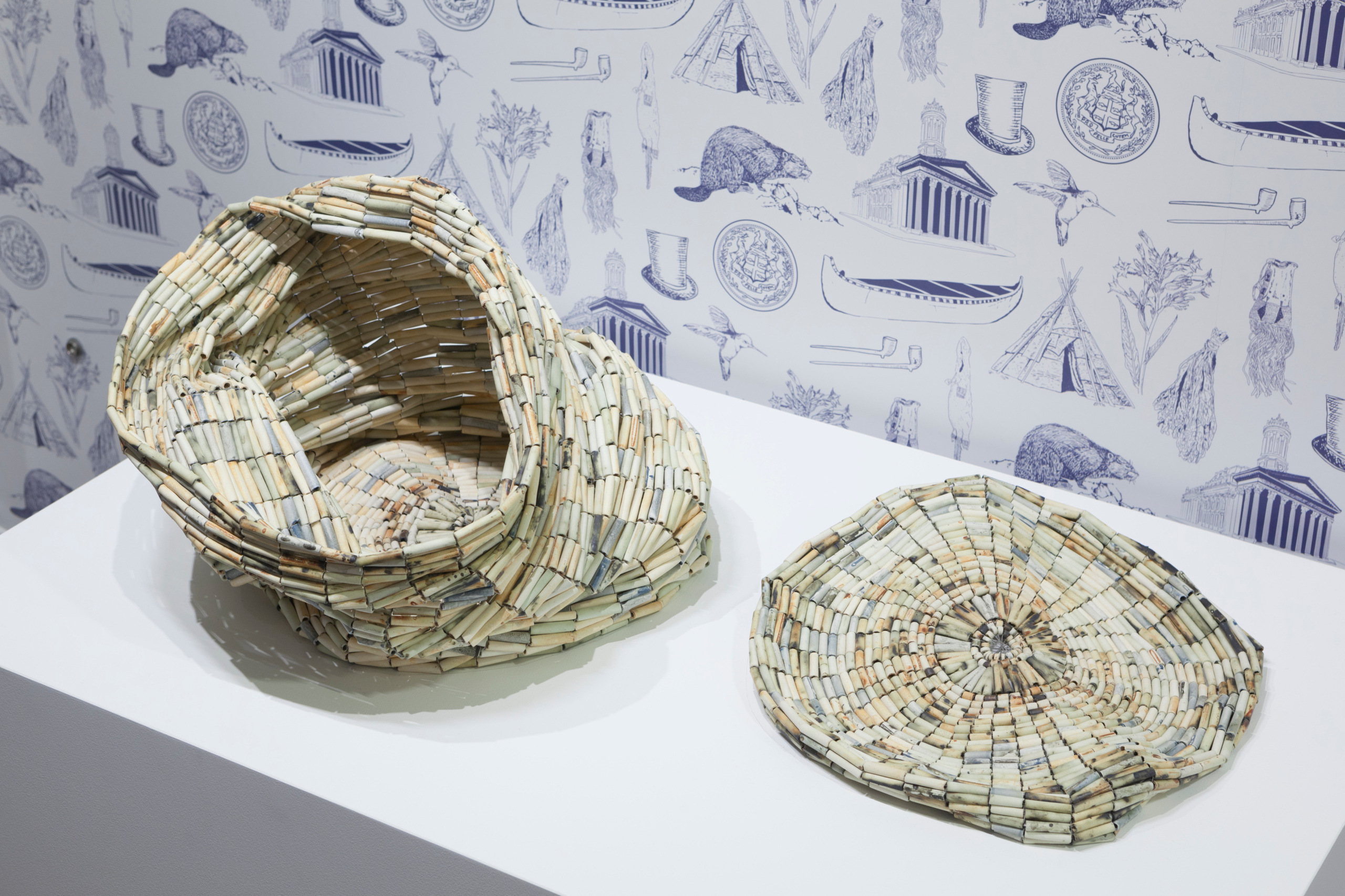     Installation view, Nadia Myre, Untitled (Tobacco Barrel), 2018. Ceramic, various oxides, stainless steel thread, stainless steel.
Photo: Darren Rigo. Courtesy of the Textile Museum of Canada. 

