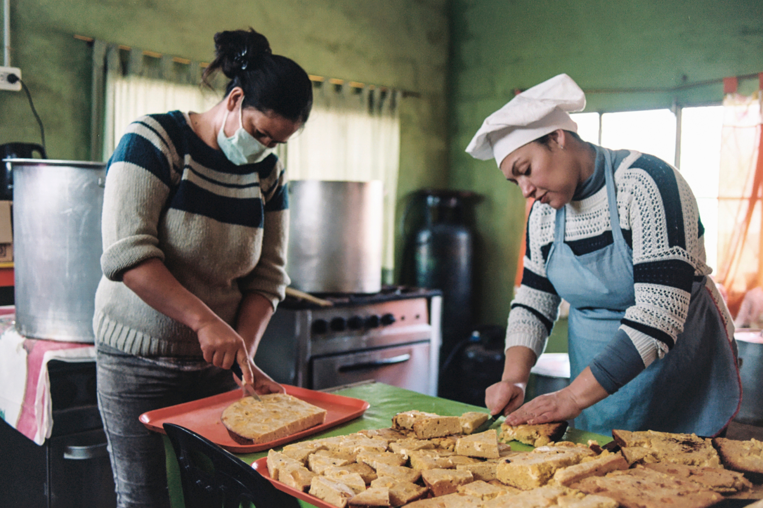     Sole and Moni, two migrant women from Paraguay, prepare a typical dish called 'sopa paraguaya' that will be distributed for their neighbors in the soup kitchen of the civil association Los Amigos of Barrio Sarmiento, Villa Ballester, San Martín, Buenos Aires, Argentina, July 24th, 2020. 
My name is Analía Cid (@analia.cid) and I'm a documentary photography, sociologist and feminist activist from Buenos Aires, Argentina. I currently work as a primary health care worker and the last year I decided to document the experiences my coworkers and I have gone through because of the coronavirus pandemic.
analiagcid@gmail.com, 04. Analia Cid &#8211; Analia-Cid-Contact_01
