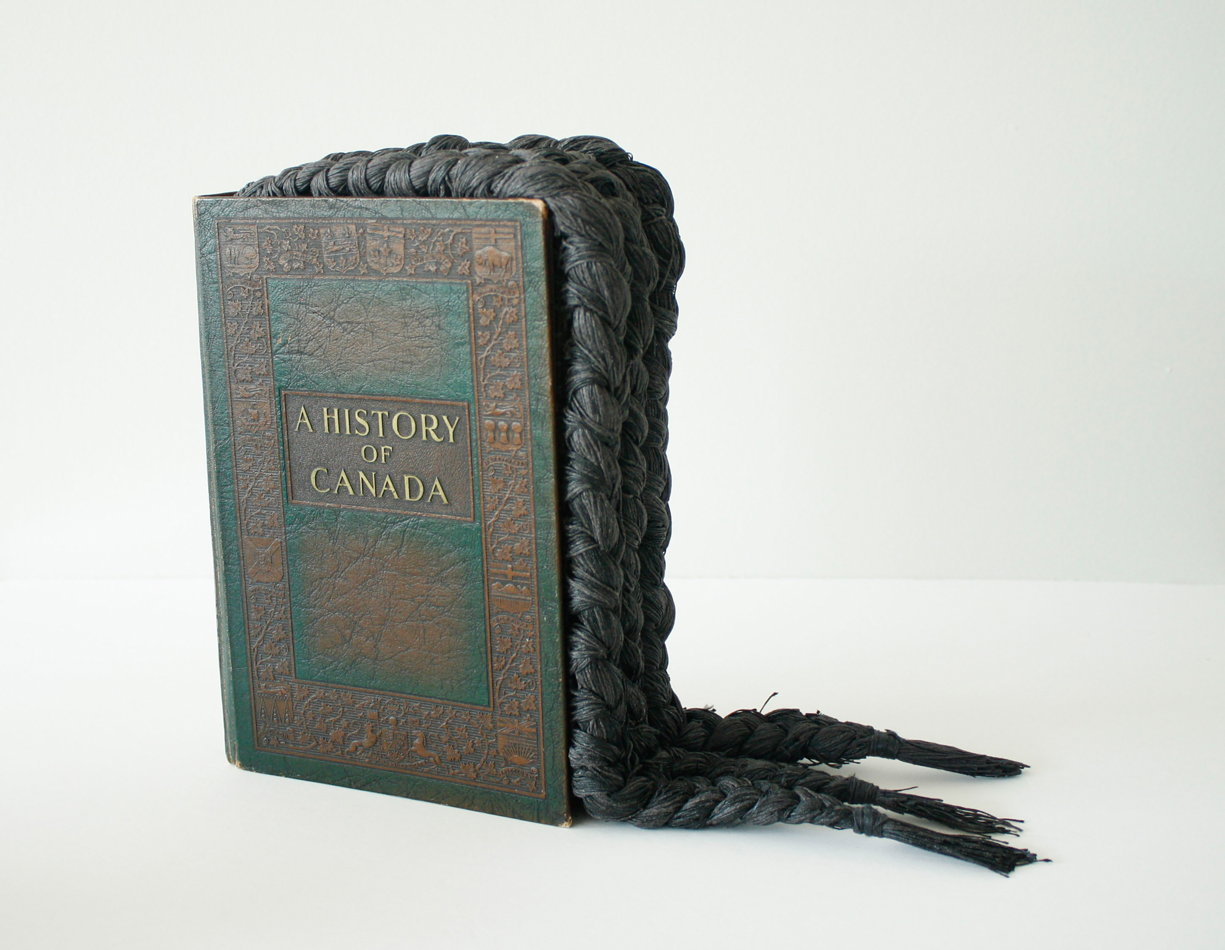 Chantal Gibson, Braided Book, 2011 (mixed-media altered text: book, photo, black waxed linen thread). Courtesy of the artist. Photo: Chantal Gibson &amp; Adrian Bisek